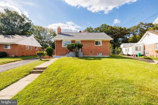 a house view with swimming pool and trees in the background