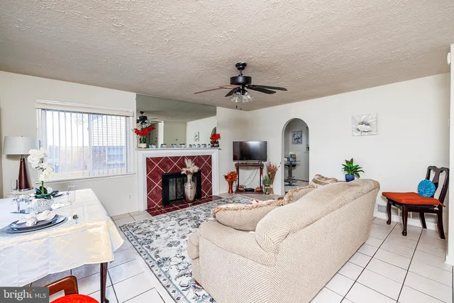 a living room with fireplace furniture and a fireplace