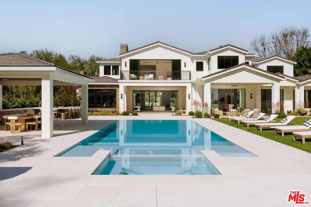 24640 Wingfield Road Hidden Hills, CA 91302 - Photo 1 of 34 a front view of a house with swimming pool and porch