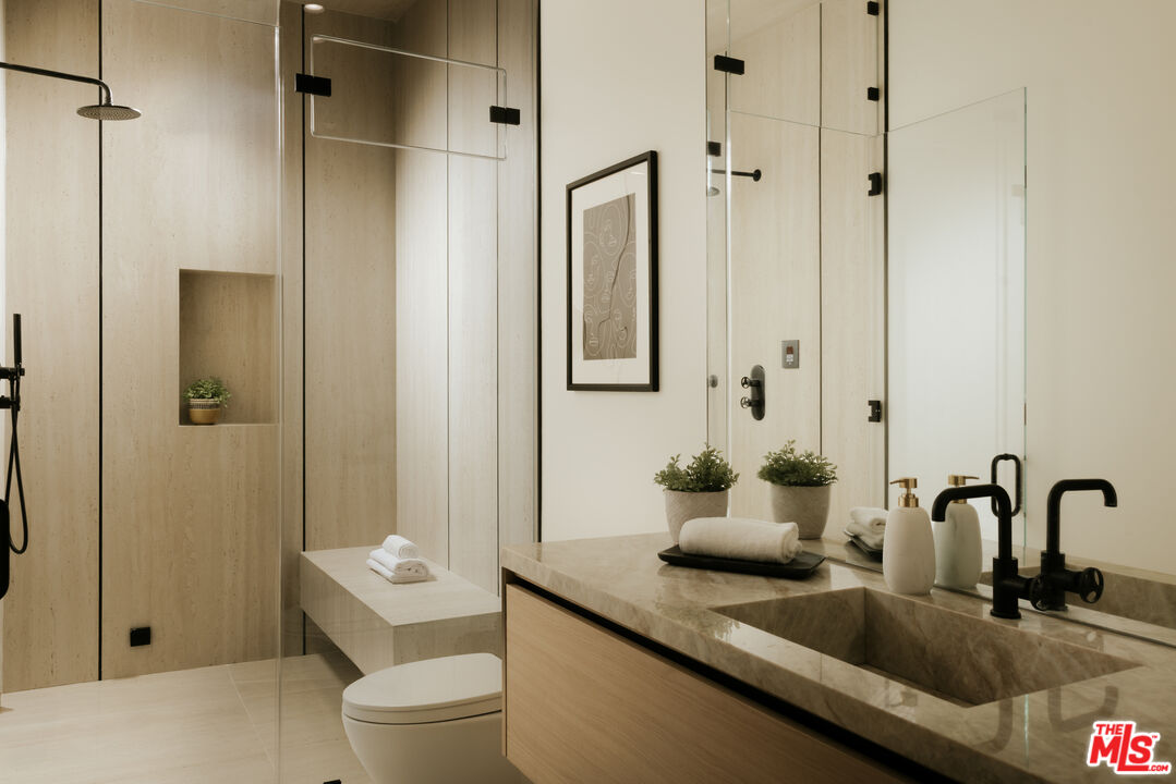 24640 Wingfield Road Hidden Hills, CA 91302 - Photo 16 of 34 a bathroom with a sink toilet and shower