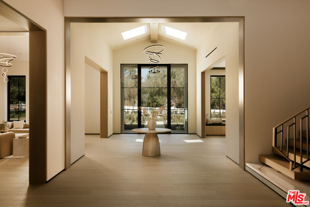 24640 Wingfield Road Hidden Hills, CA 91302 - Photo 2 of 34 a view of a hallway with living room and utility room