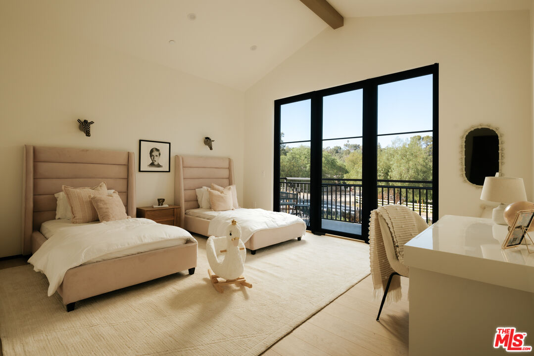 24640 Wingfield Road Hidden Hills, CA 91302 - Photo 25 of 34 a bedroom with two beds and large window