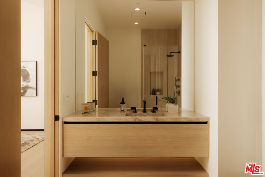24640 Wingfield Road Hidden Hills, CA 91302 - Photo 26 of 34 a bathroom with a mirror and a sink