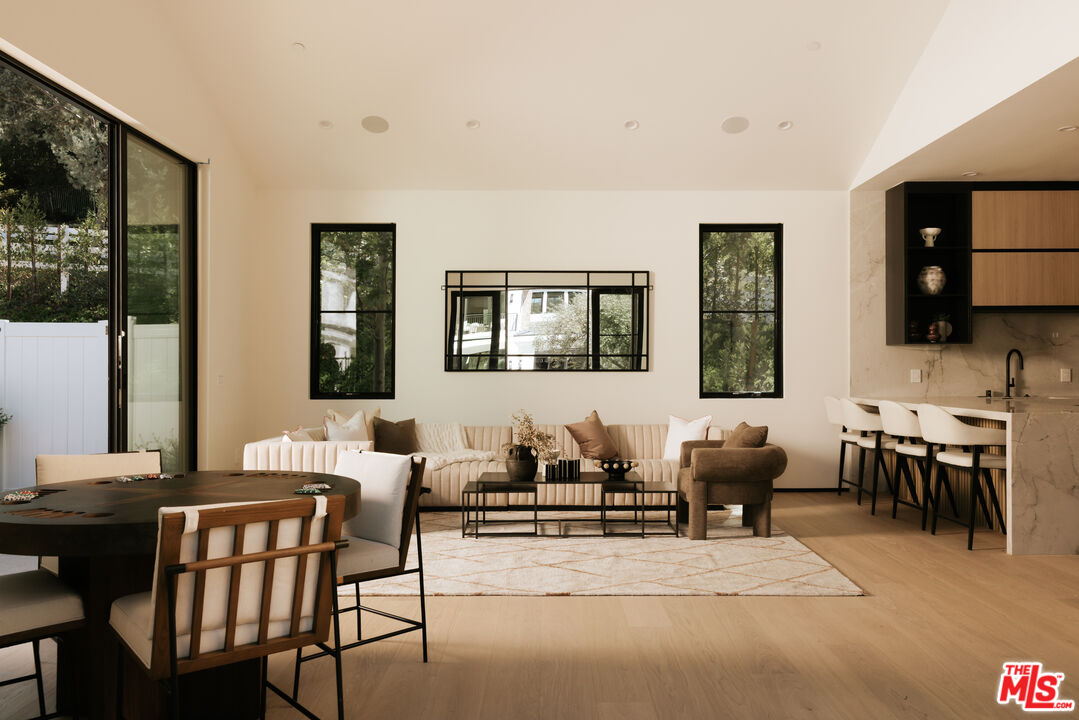 24640 Wingfield Road Hidden Hills, CA 91302 - Photo 30 of 34 a living room with furniture a flat screen tv and large windows