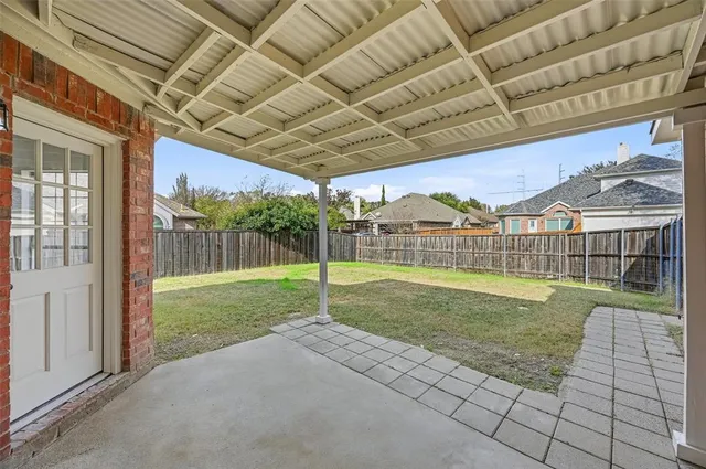 a view of a house with a yard and sitting area