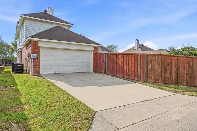 an aerial view of a house with swimming pool and outdoor seating