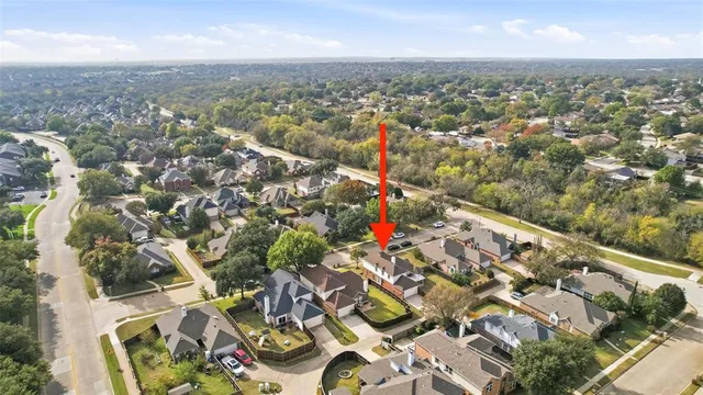 an aerial view of residential houses with outdoor space and swimming pool