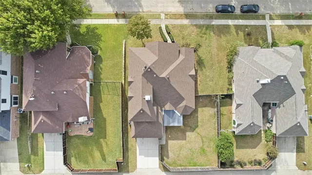 a view of a house with a big yard and large trees