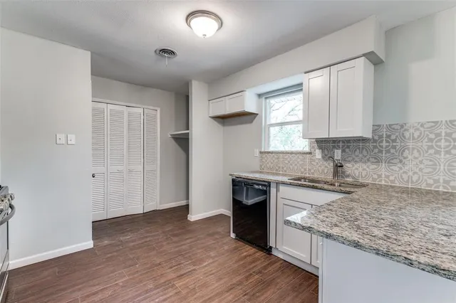 an empty room with wooden floor and a window