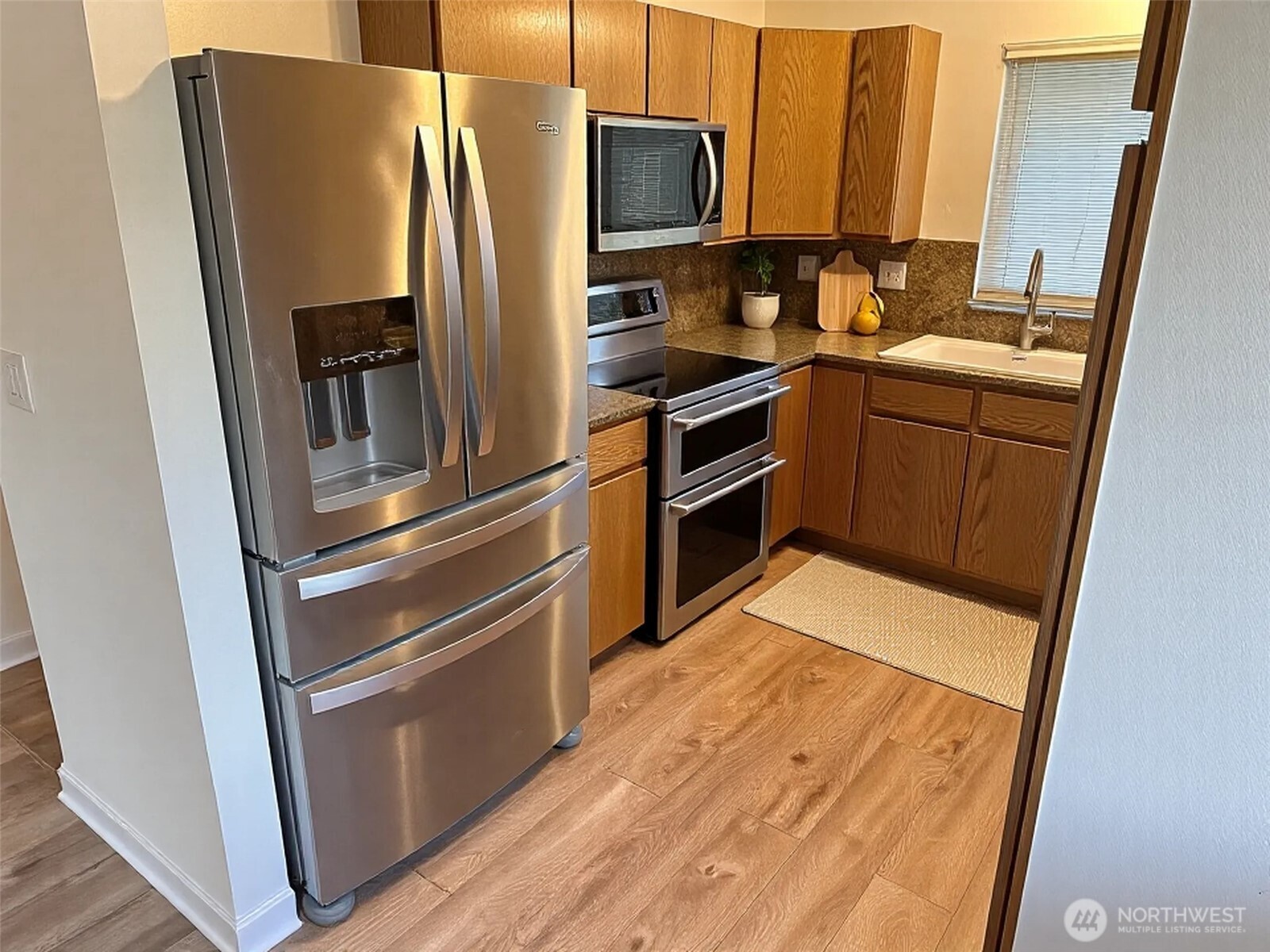 21923 3rd Place West Bothell, WA 98021 - Photo 8 of 19 a kitchen with stainless steel appliances a refrigerator stove and sink