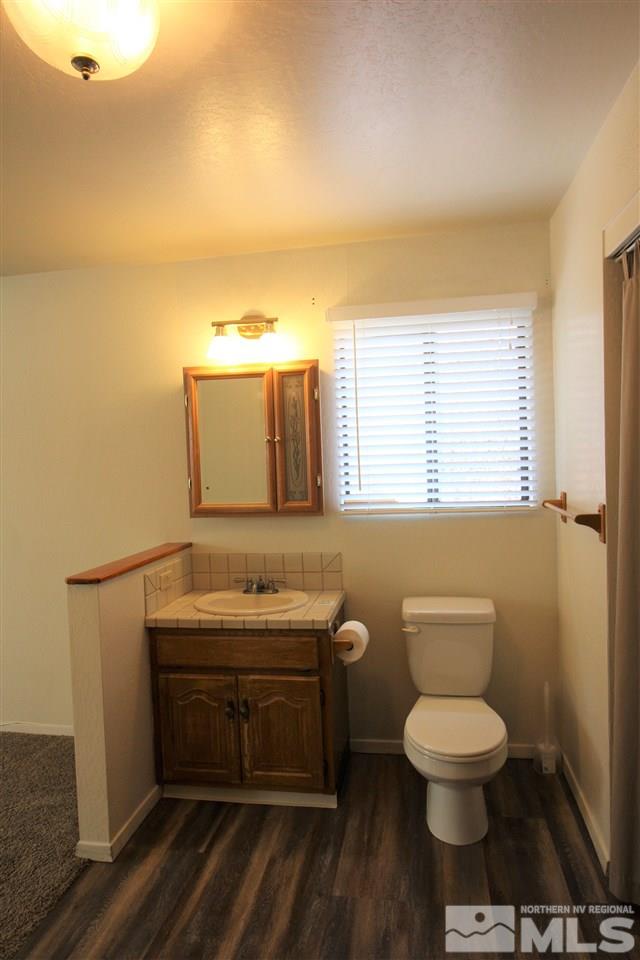 2005 Watt Street Reno, NV 89509 - Photo 16 of 29 a bathroom with a toilet a sink and mirror