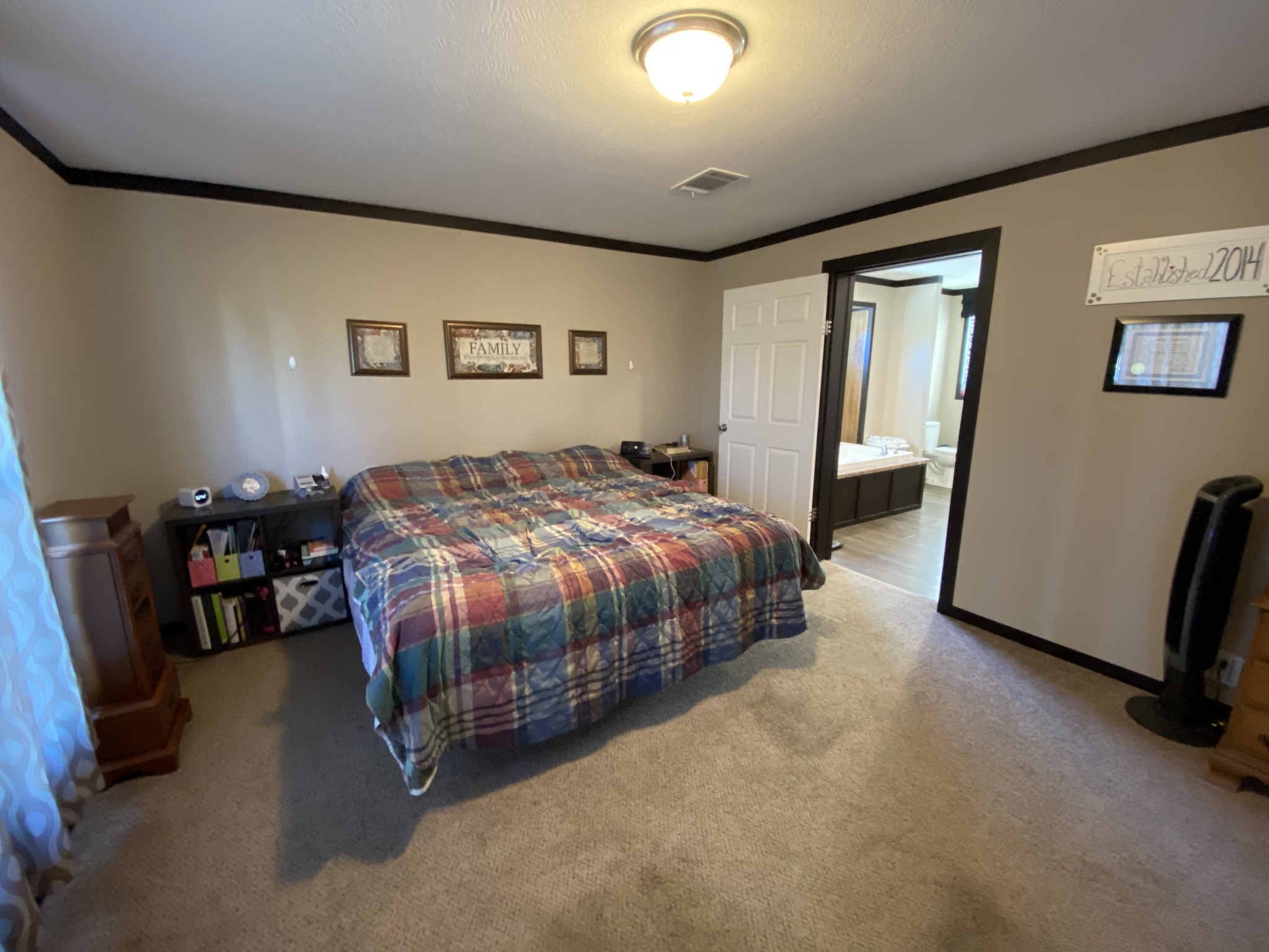 255 Rascal Town Road Loretto, TN 38469 - Photo 17 of 54 a spacious bedroom with a bed a couch and a desk in it