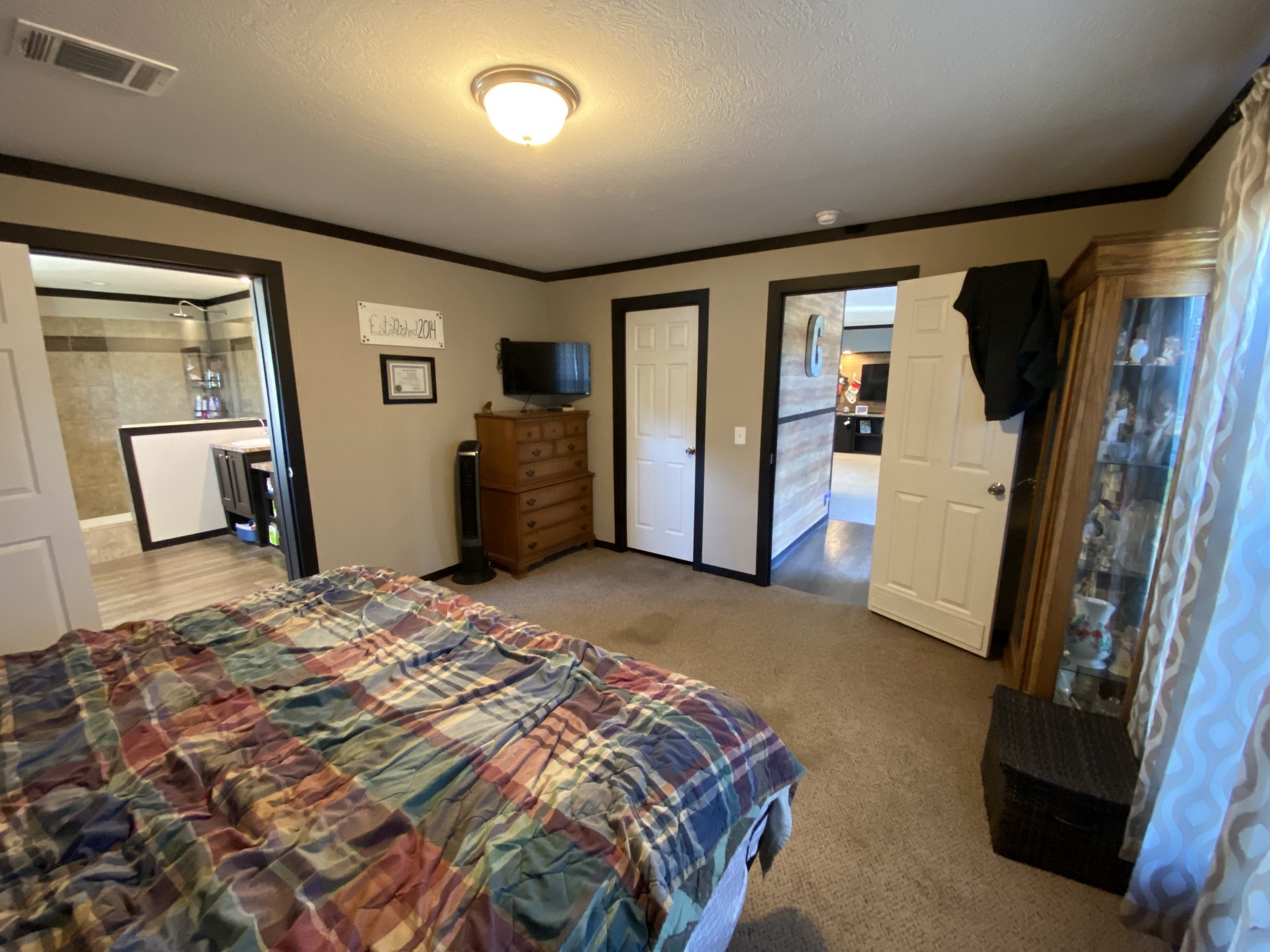 255 Rascal Town Road Loretto, TN 38469 - Photo 18 of 54 a bedroom with a bed and a flat screen tv