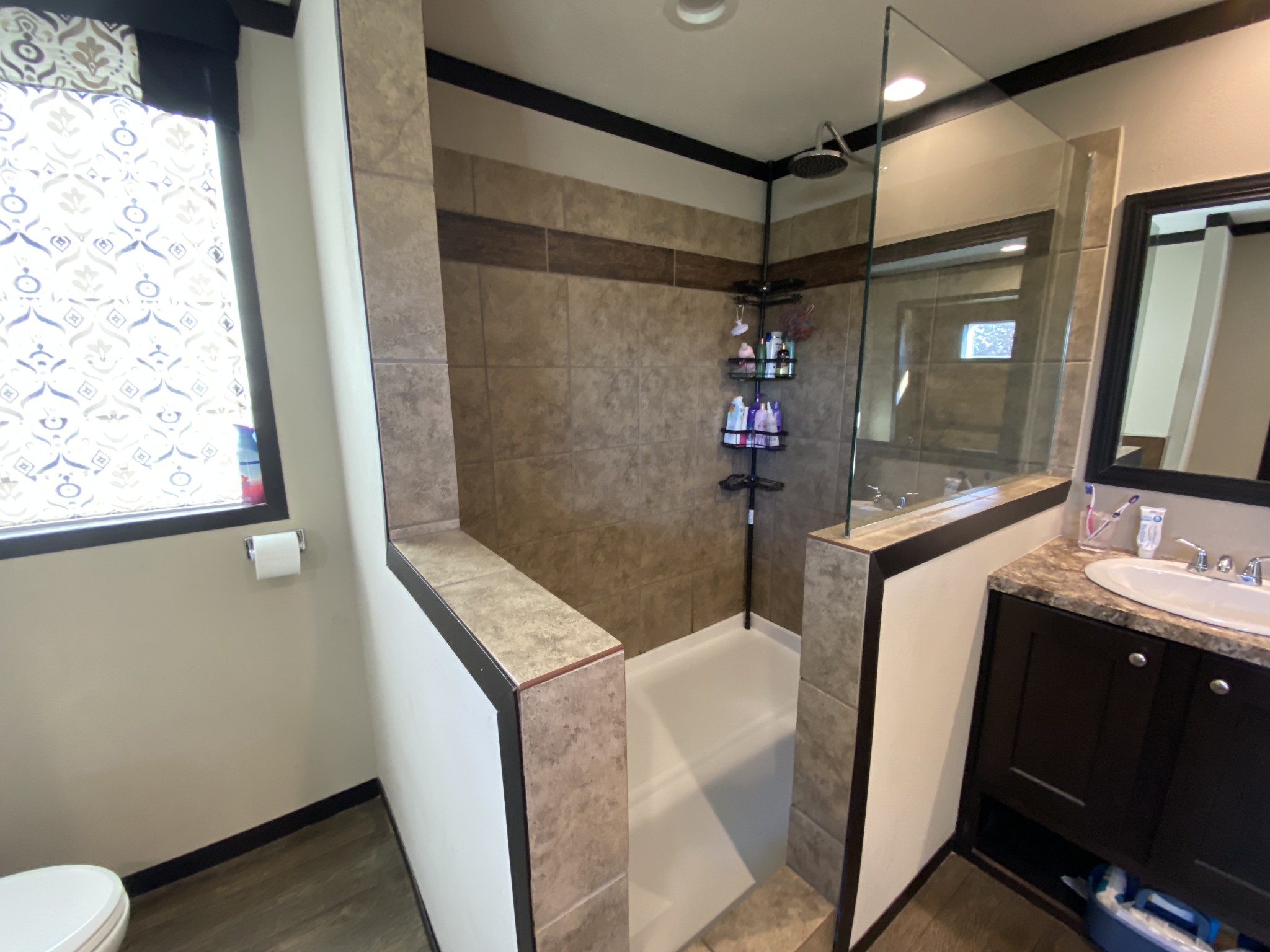 255 Rascal Town Road Loretto, TN 38469 - Photo 24 of 54 a bathroom with a sink a mirror and a shower