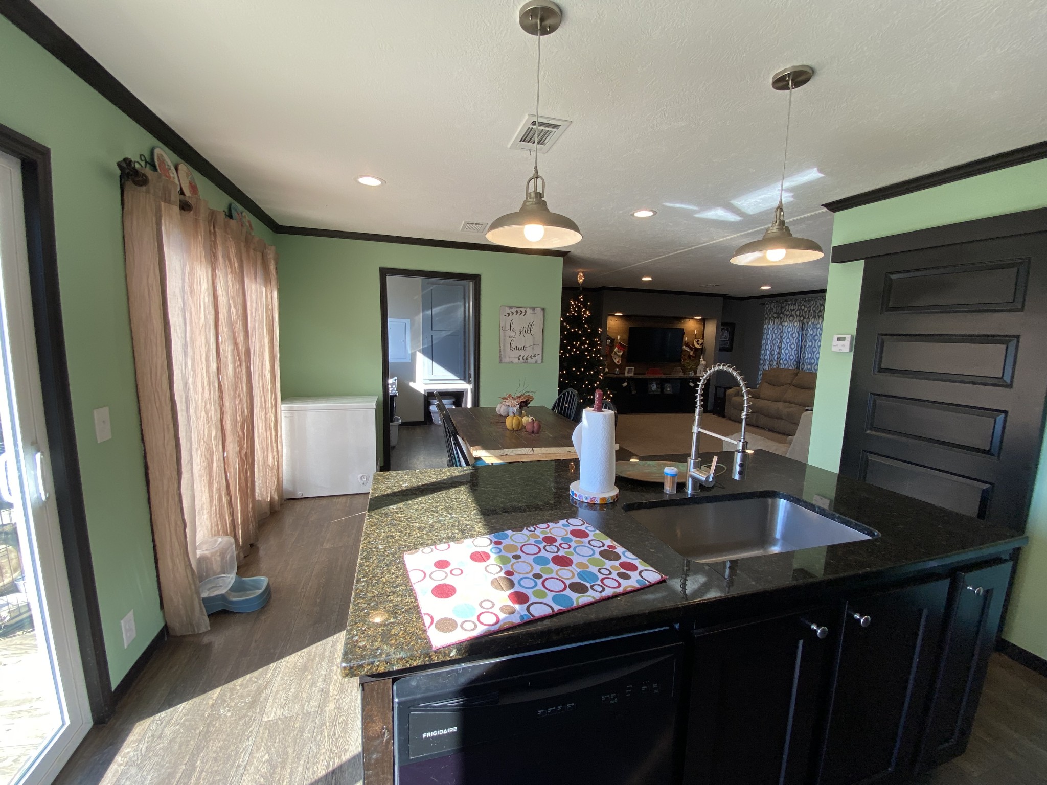 255 Rascal Town Road Loretto, TN 38469 - Photo 31 of 54 a kitchen with stainless steel appliances granite countertop a stove a sink dishwasher and a refrigerator with wooden floor