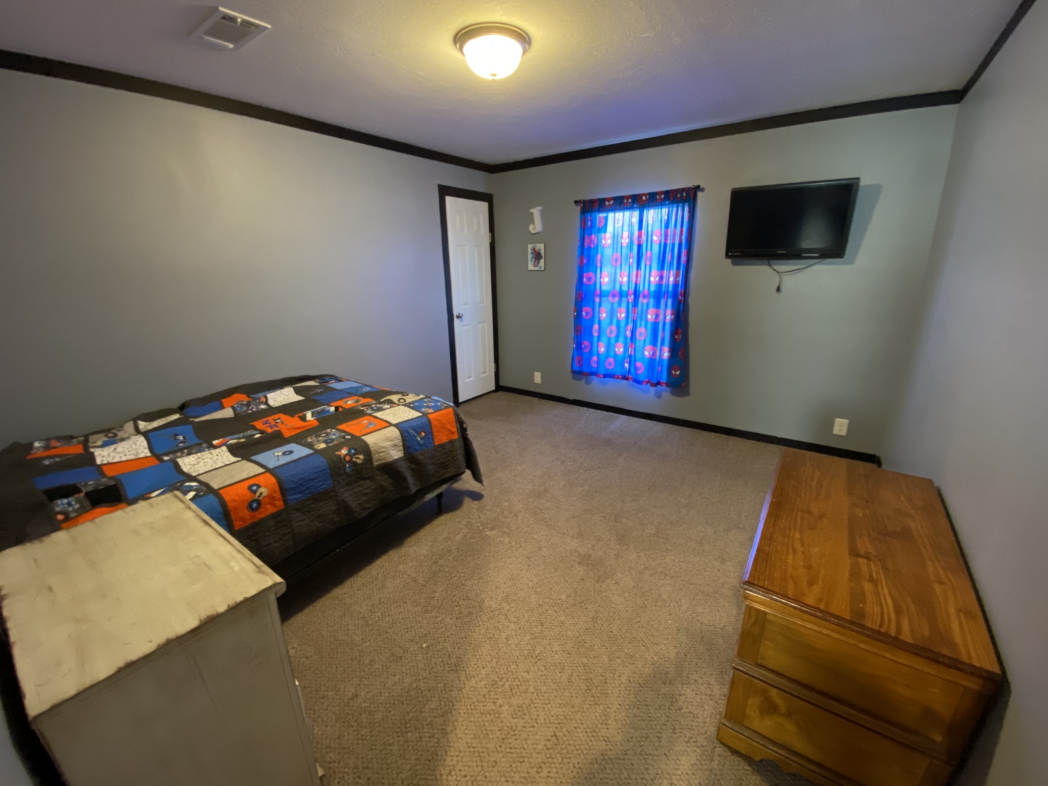 255 Rascal Town Road Loretto, TN 38469 - Photo 42 of 54 a bedroom with a bed and a flat screen tv