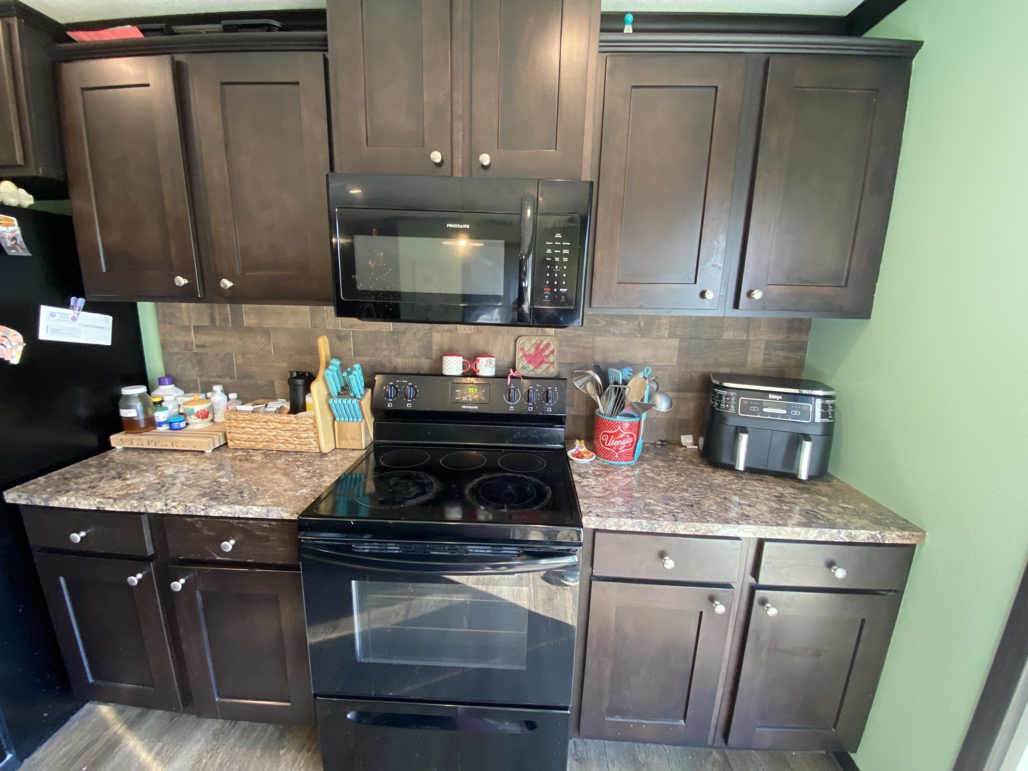 255 Rascal Town Road Loretto, TN 38469 - Photo 52 of 54 a kitchen with granite countertop wood cabinets and white appliances