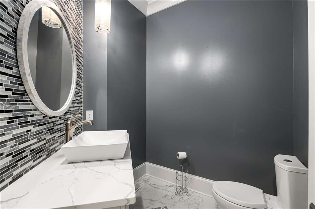 2340 Thisel Down Drive Statham, GA 30666 - Photo 12 of 105 a bathroom with a toilet mirror and sink