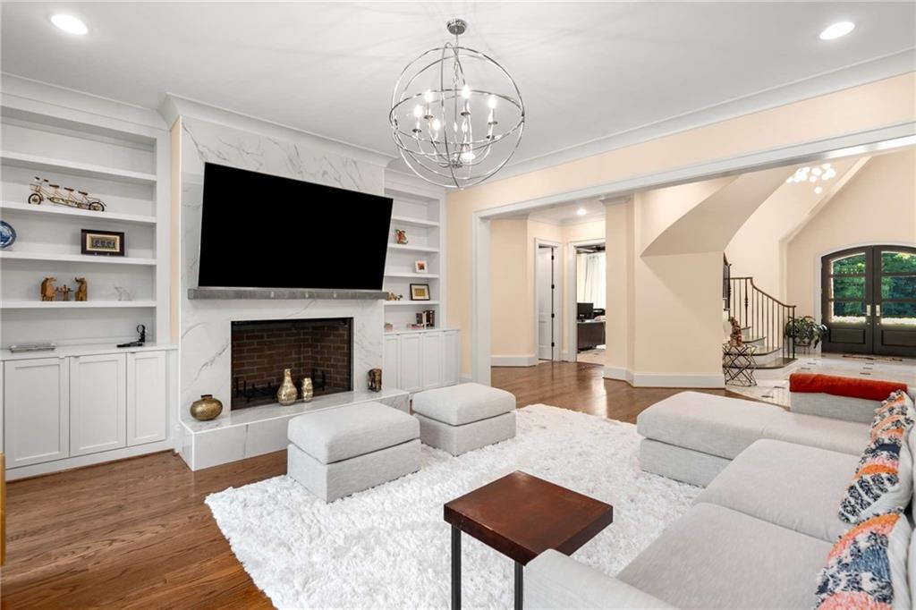 2340 Thisel Down Drive Statham, GA 30666 - Photo 16 of 105 a living room with furniture a flat screen tv and a fireplace