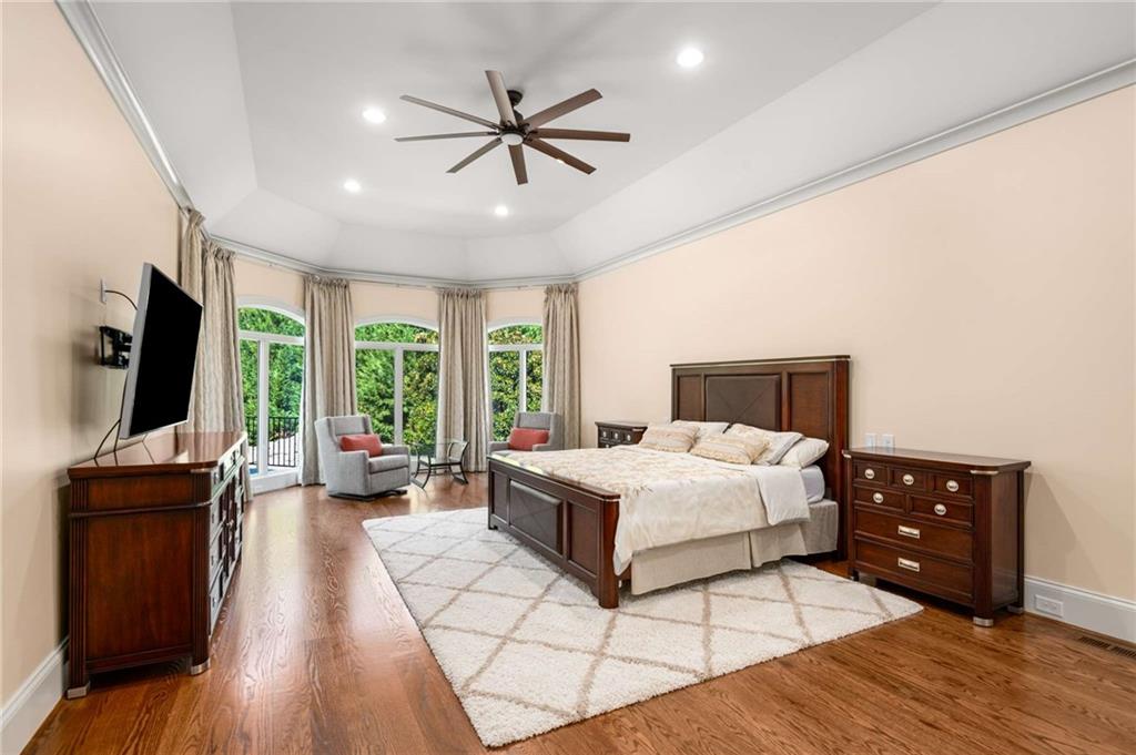 2340 Thisel Down Drive Statham, GA 30666 - Photo 17 of 105 a bedroom with a bed and a flat tv screen on dresser