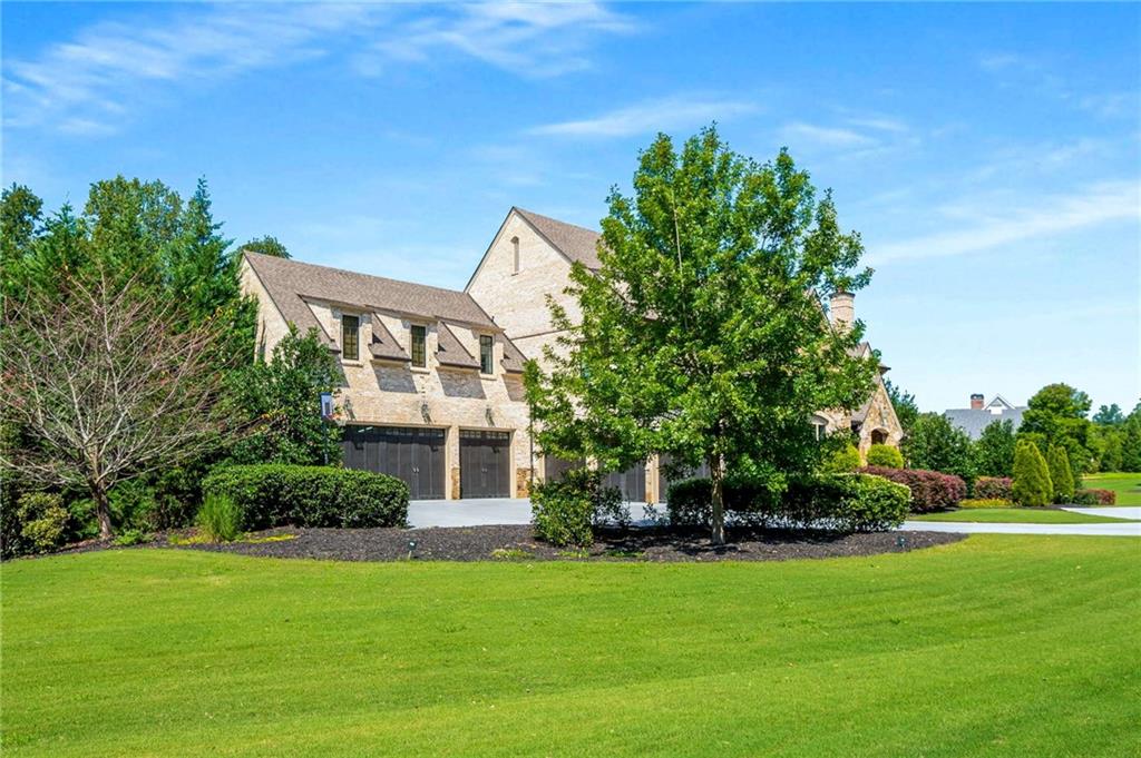 2340 Thisel Down Drive Statham, GA 30666 - Photo 2 of 105 a front view of a house with a garden