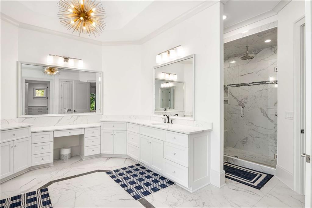 2340 Thisel Down Drive Statham, GA 30666 - Photo 22 of 105 a spacious bathroom with a shower a sink and a mirror