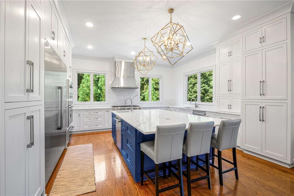 2340 Thisel Down Drive Statham, GA 30666 - Photo 37 of 105 a view of a dining room with furniture a chandelier and wooden floor