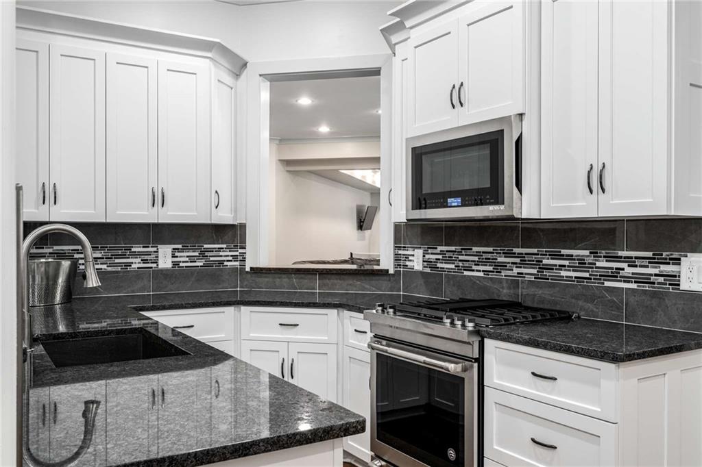 2340 Thisel Down Drive Statham, GA 30666 - Photo 83 of 105 a kitchen with granite countertop a sink a stove and cabinets