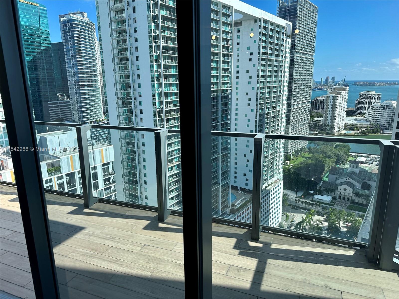 68 Southeast 6th Street, Unit 2707 Miami, FL 33131 - Photo 19 of 53 a view of a balcony with a floor to ceiling window