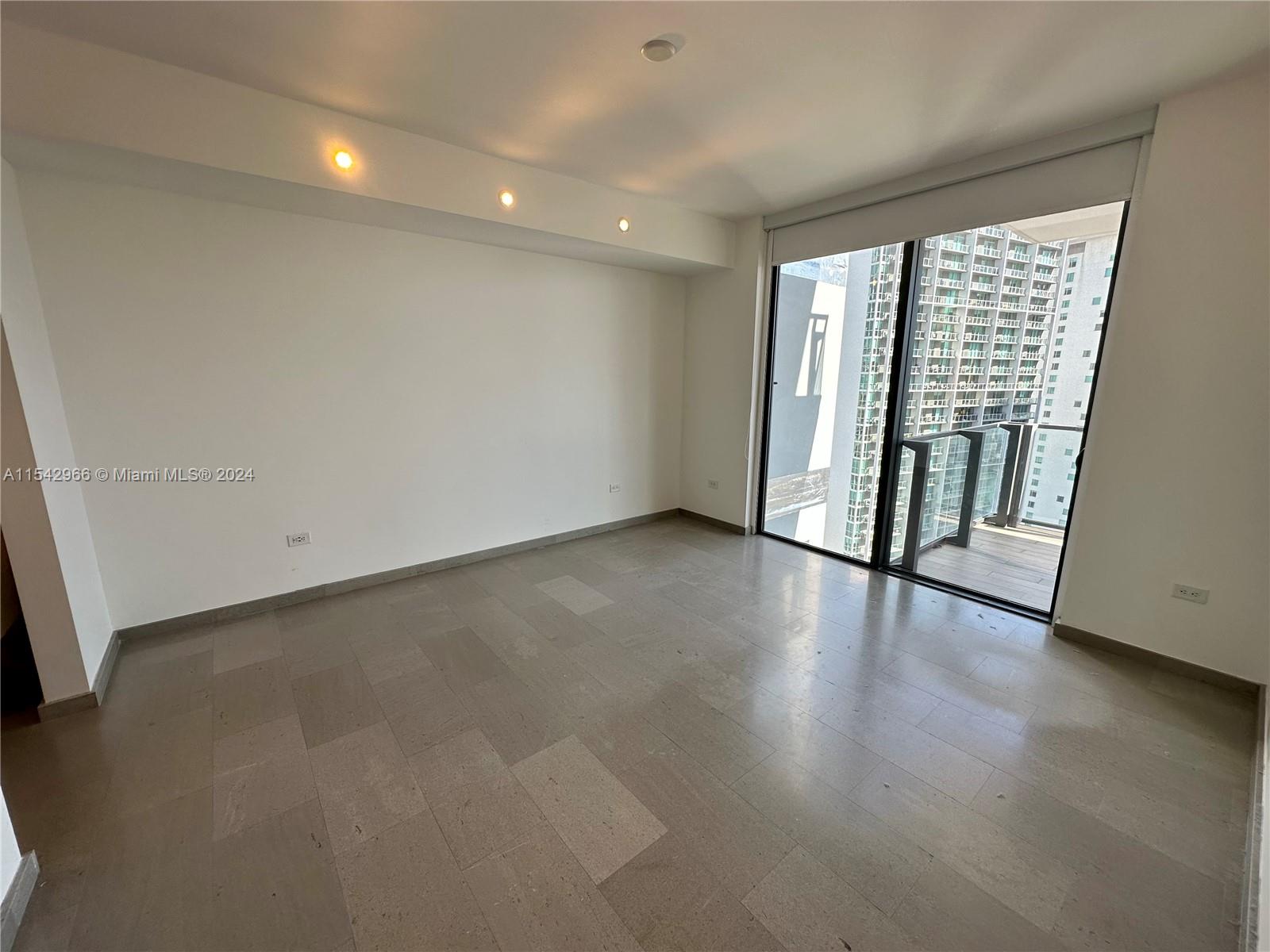 68 Southeast 6th Street, Unit 2707 Miami, FL 33131 - Photo 23 of 53 wooden floor in an empty room with a window