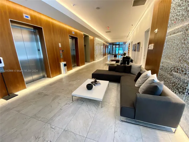 a lobby with furniture and a potted plant