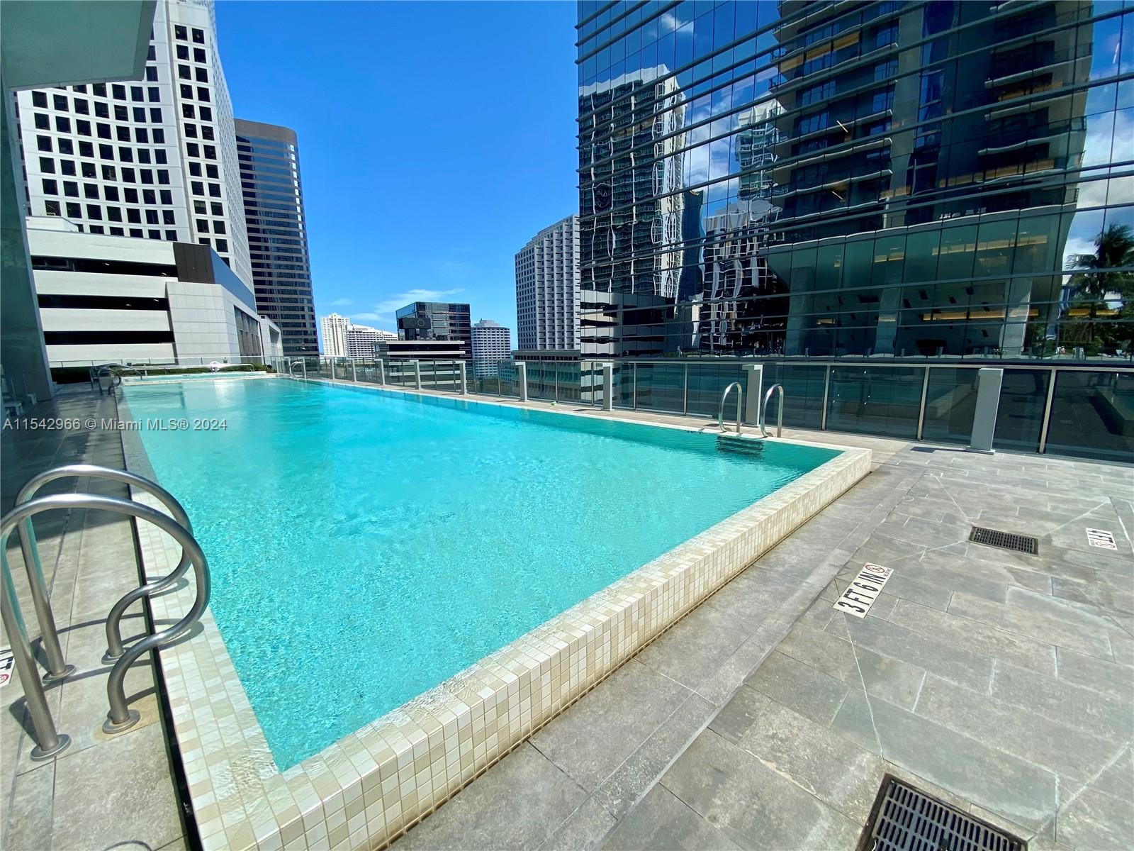 68 Southeast 6th Street, Unit 2707 Miami, FL 33131 - Photo 41 of 53 a view of swimming pool outdoor seating and city view