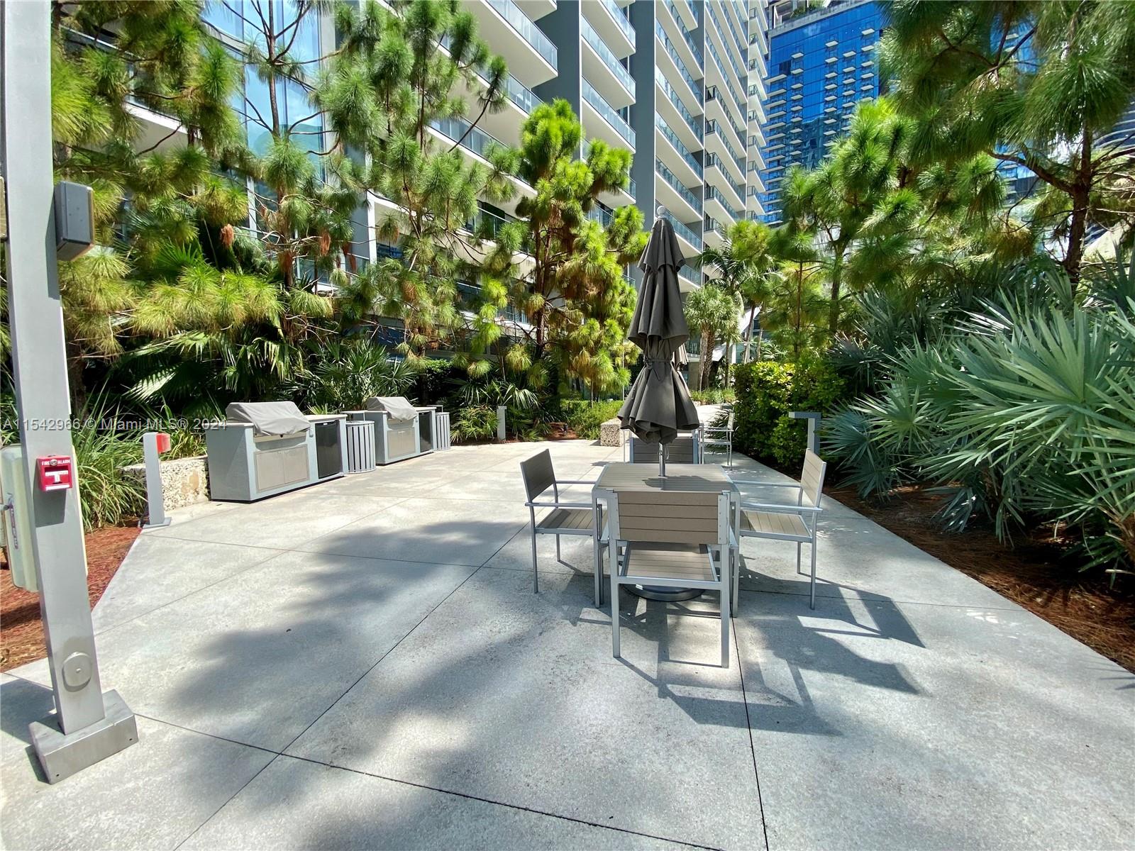 68 Southeast 6th Street, Unit 2707 Miami, FL 33131 - Photo 46 of 53 a view of a backyard with sitting area