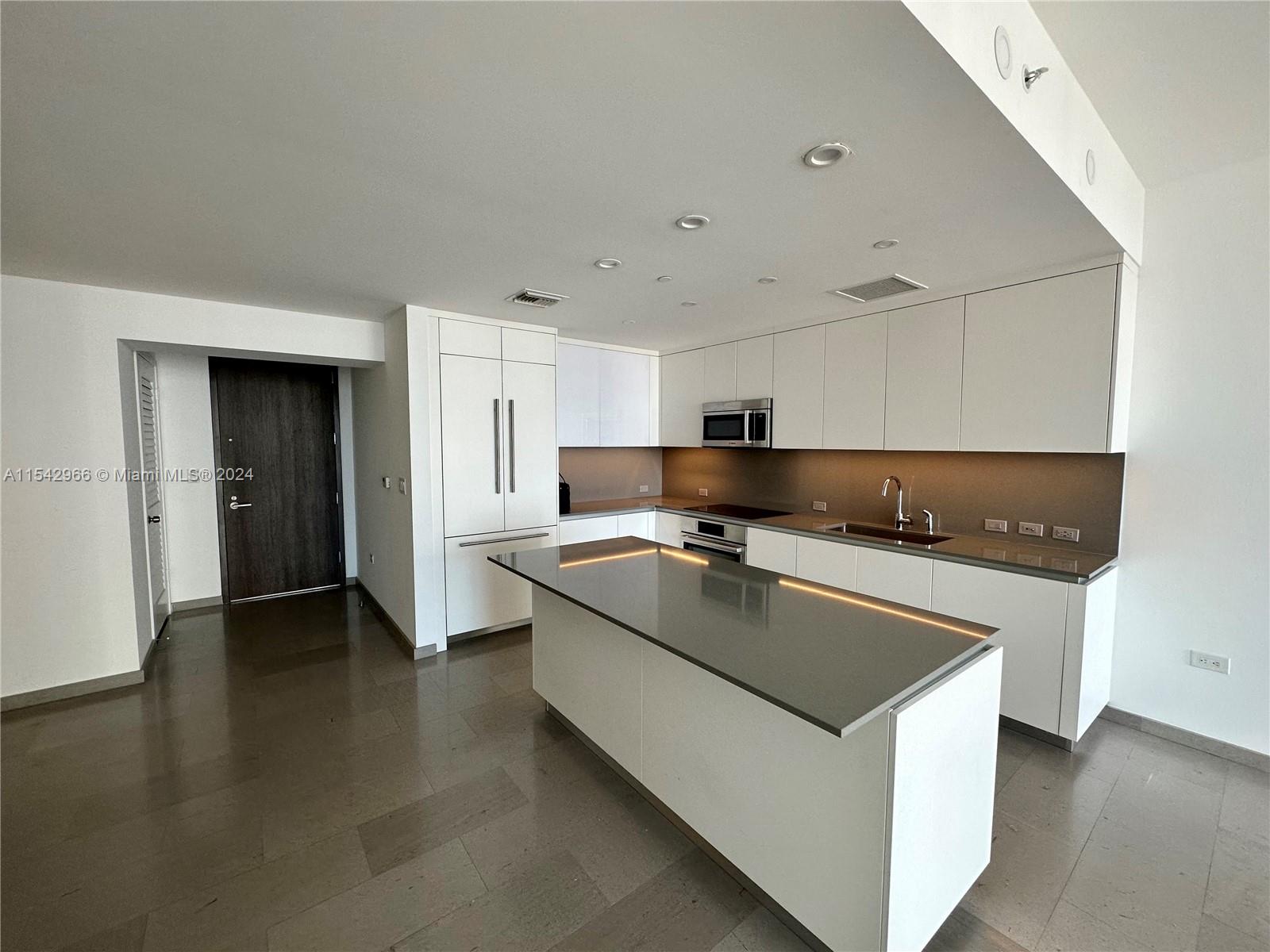 68 Southeast 6th Street, Unit 2707 Miami, FL 33131 - Photo 5 of 53 a kitchen with stainless steel appliances granite countertop a sink a stove and a refrigerator