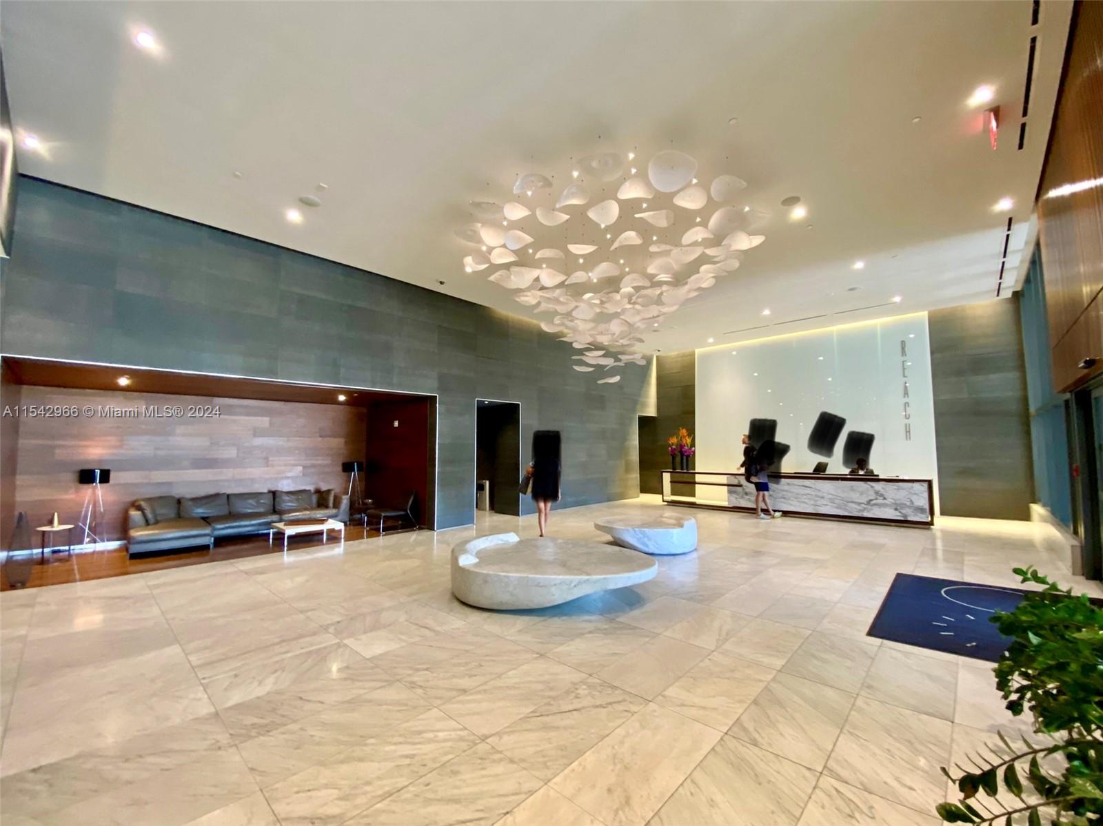 68 Southeast 6th Street, Unit 2707 Miami, FL 33131 - Photo 52 of 53 a view of a living room and kitchen