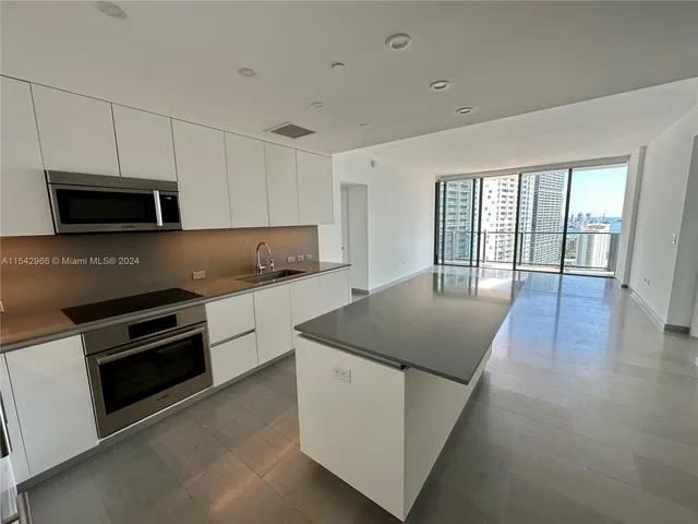 a kitchen with granite countertop a stove and a sink