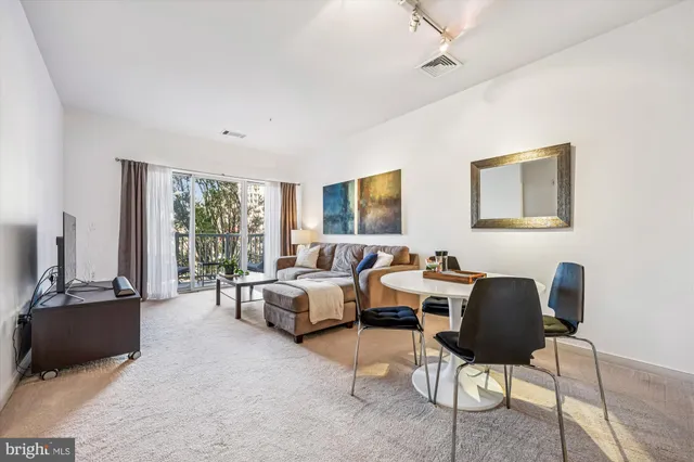 a kitchen with a refrigerator and a chair