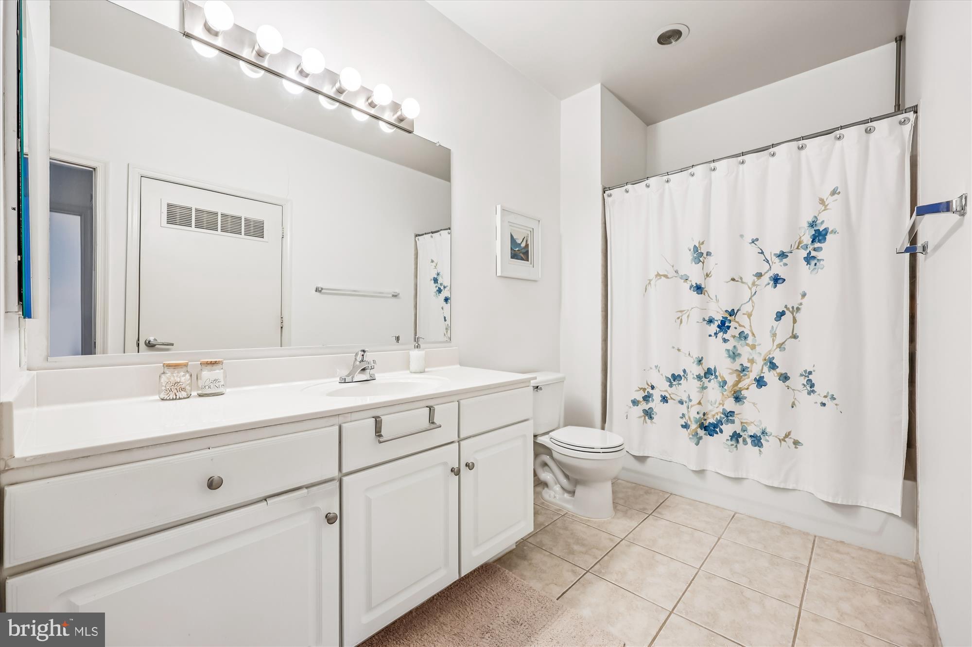 8045 Newell Street, Unit 215 Silver Spring, MD 20910 - Photo 21 of 31 a bathroom with a double vanity sink toilet and shower