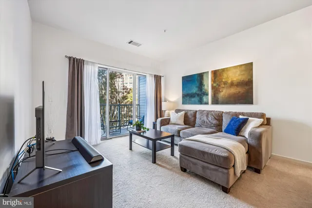 a balcony with chairs and with potted plants
