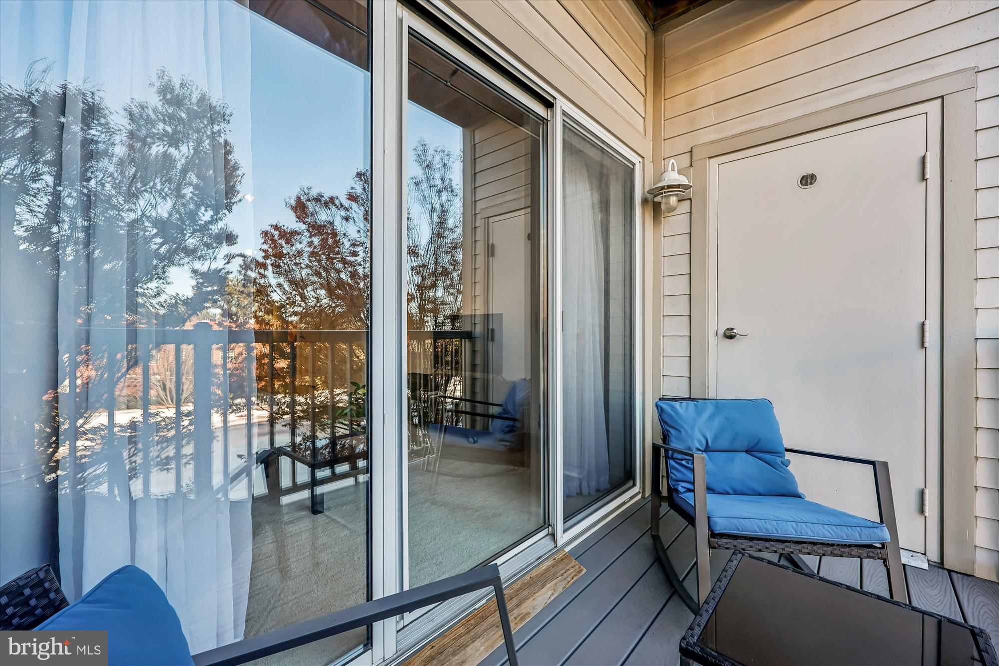 8045 Newell Street, Unit 215 Silver Spring, MD 20910 - Photo 23 of 31 a balcony with chairs and with potted plants
