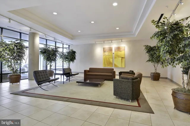 a living room with lots of furniture and a large window