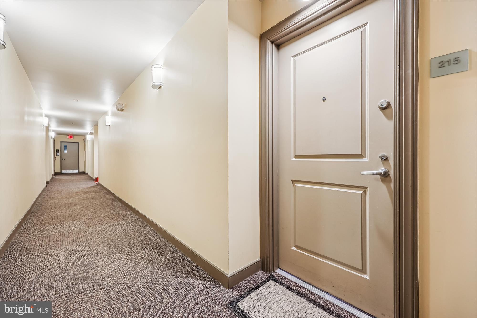 8045 Newell Street, Unit 215 Silver Spring, MD 20910 - Photo 9 of 31 a view of a hallway with closet