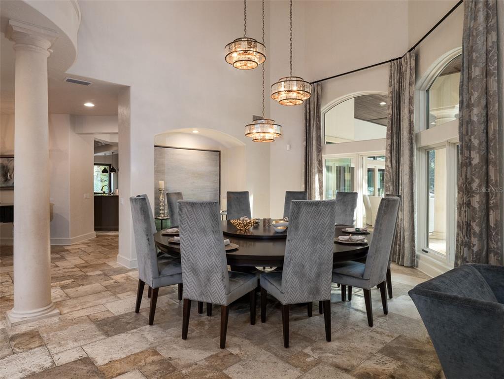 10803 Southwest 27 Avenue Gainesville, FL 32608 - Photo 15 of 78 a view of a dining room with furniture and a chandelier
