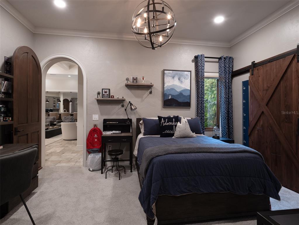 10803 Southwest 27 Avenue Gainesville, FL 32608 - Photo 37 of 78 a bedroom with bed and a mirror