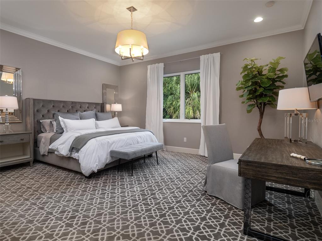 10803 Southwest 27 Avenue Gainesville, FL 32608 - Photo 42 of 78 a bedroom with a bed and a chandelier