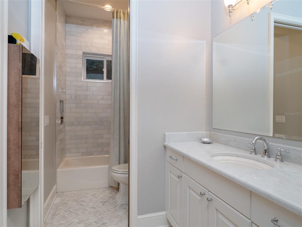 10803 Southwest 27 Avenue Gainesville, FL 32608 - Photo 47 of 78 a bathroom with a granite countertop sink toilet and shower