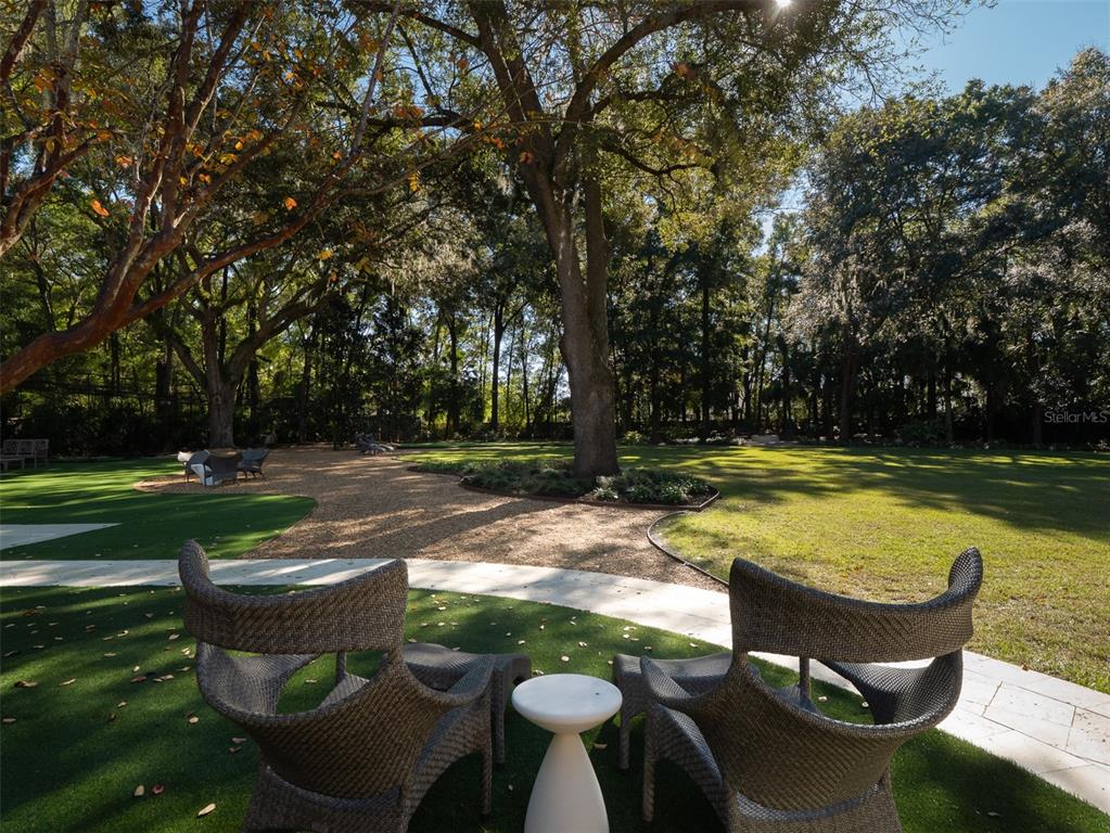 10803 Southwest 27 Avenue Gainesville, FL 32608 - Photo 8 of 78 a view of a swimming pool with lawn chairs and a yard