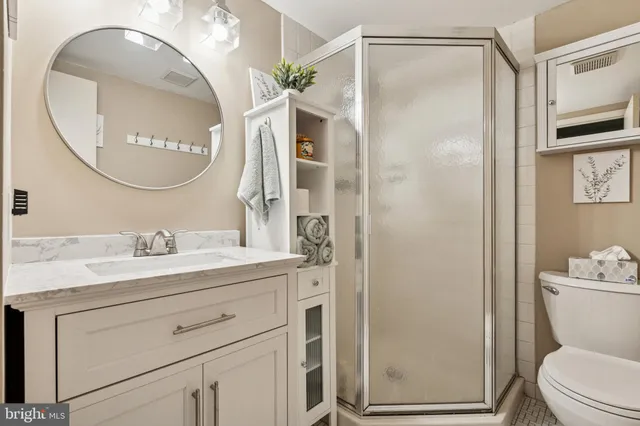 a bathroom with a sink a toilet and a mirror