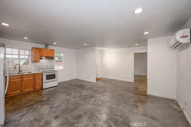 a large kitchen with stainless steel appliances a large counter top and oven