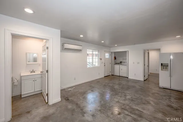 en empty room with windows and bathroom